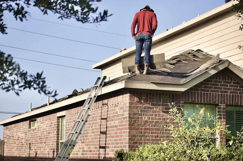 Professional roofer working on a residential roof in Meadows at Westwoods